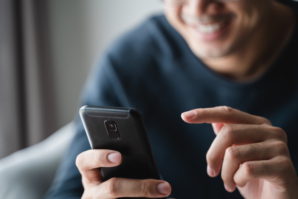 Man Happy Using Smart Phone